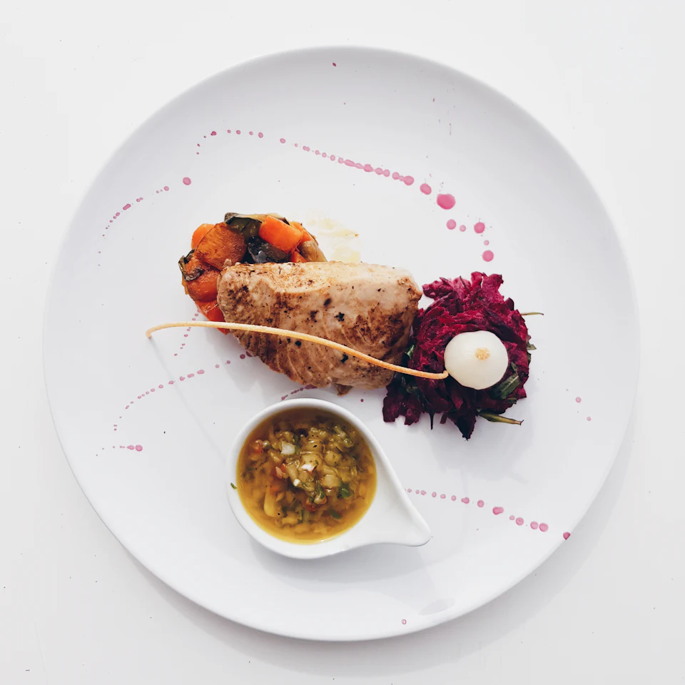 Flat-lay photography of cooked meat and sauce platter