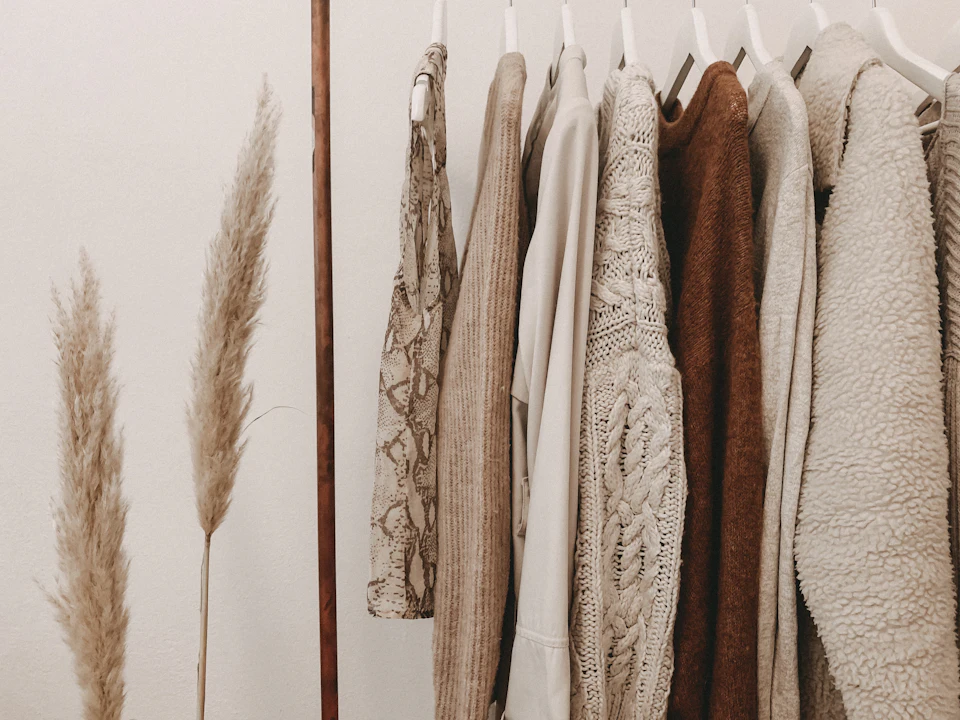Hanged top on brown and white clothes horse