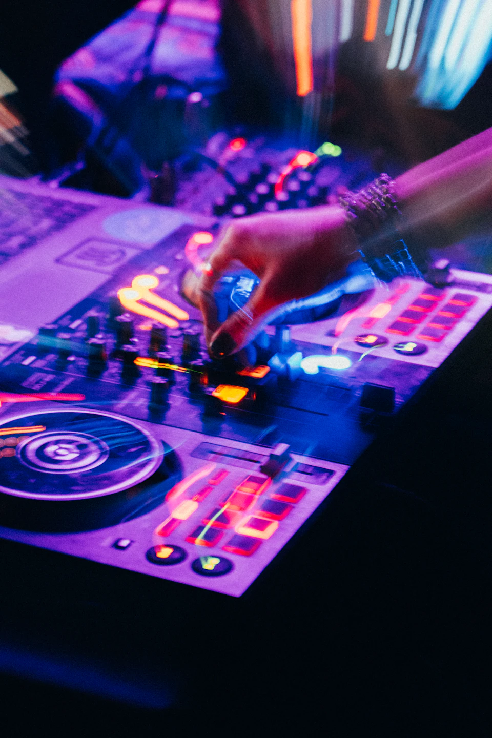Dj mixing music with colorful lights